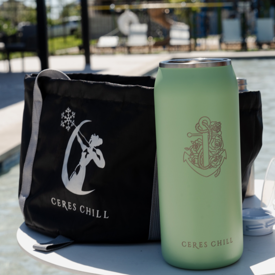 Ceres Chill breast milk chiller and wash basin bag on a table with a children's playground in the background. 