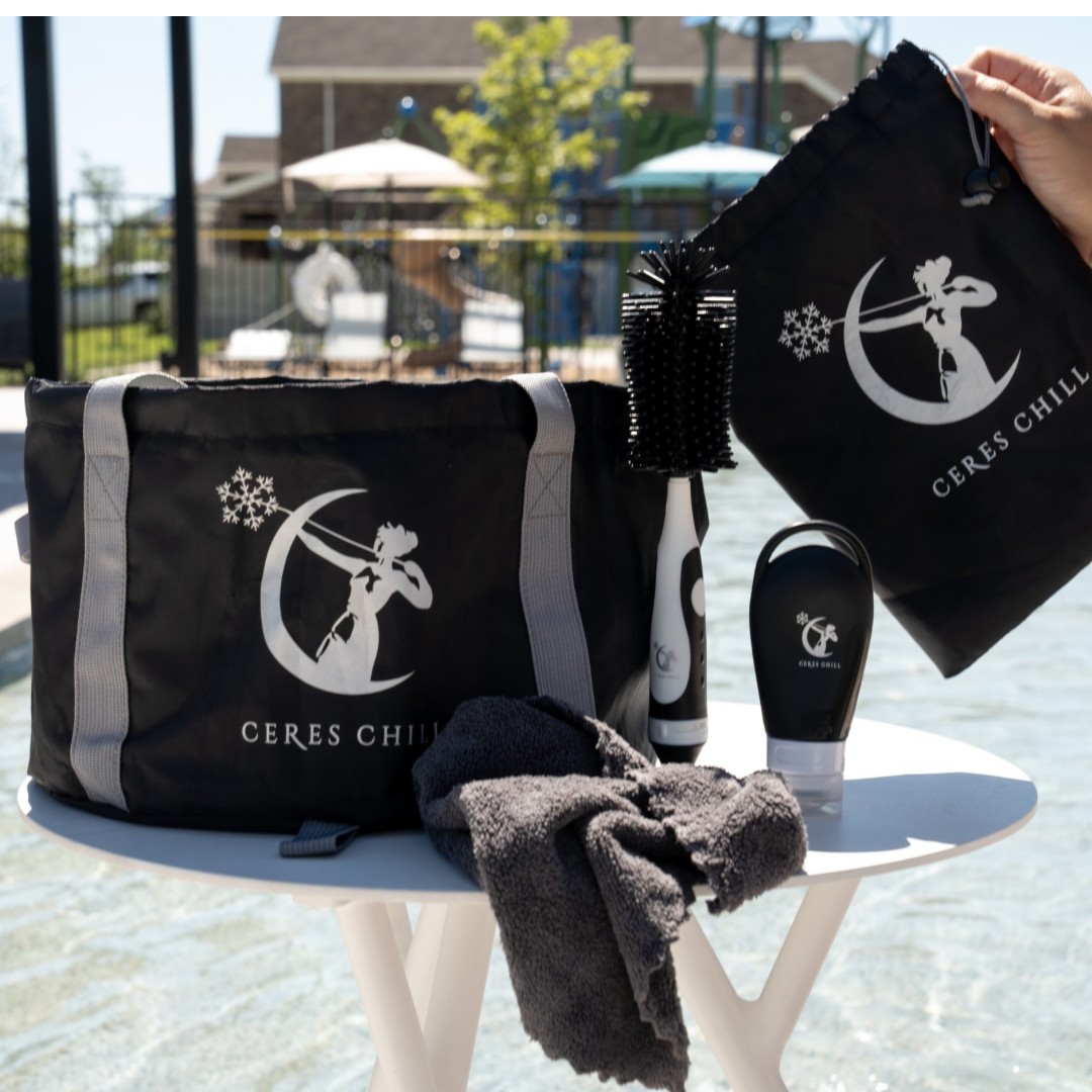 Ceres Chill Wash Basin bag, soap dispenser, towel, and brush on a table with a playground in the backdrop.