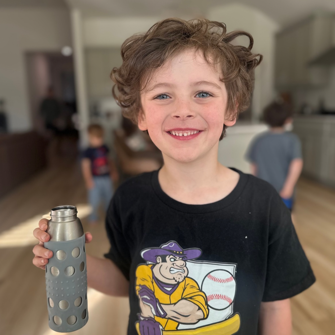 A child holding a Ceres Chill Inner Chamber using the silicon sleeve. 