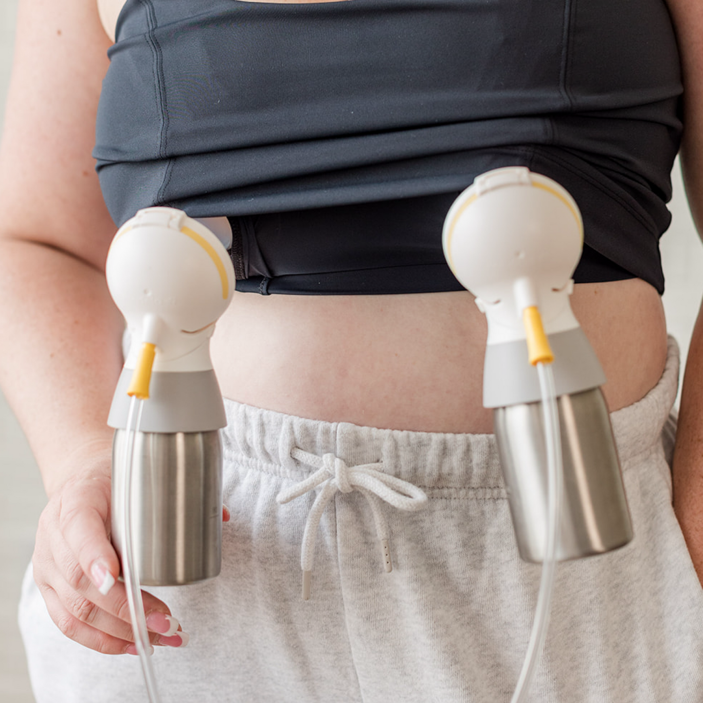 A woman using her Ceres Chill Inner Chambers to double pump with a breast pump. 