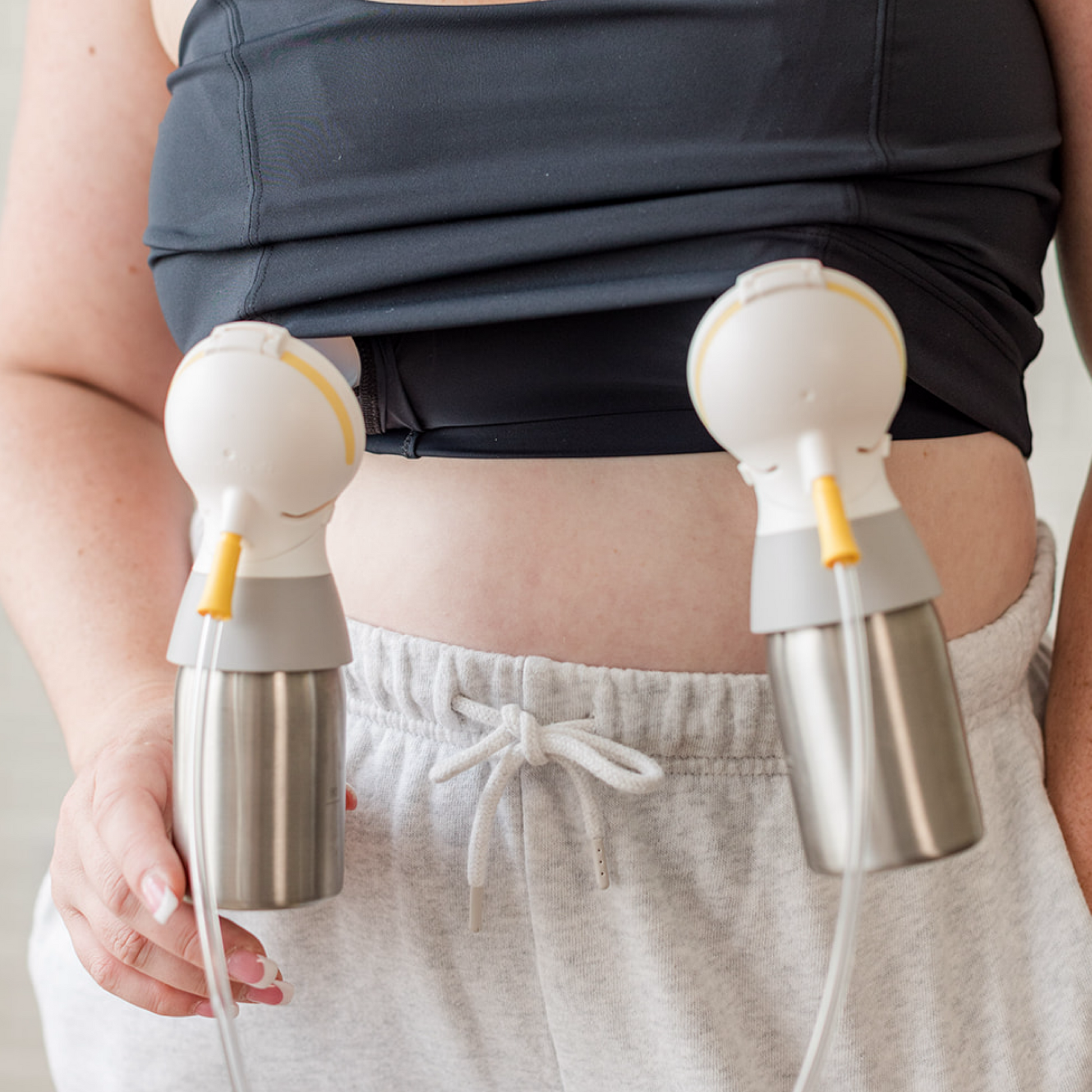 A woman using her Ceres Chill Inner Chambers to double pump with a breast pump. 