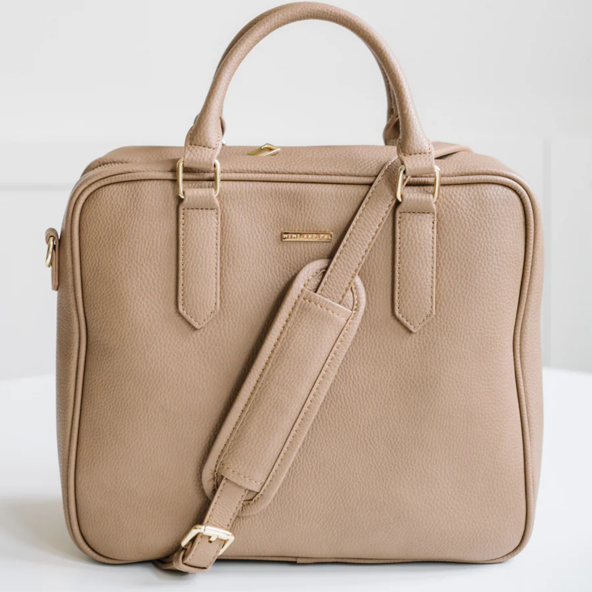 Beige handbag with a shoulder strap on a white background