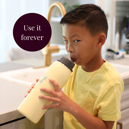 Child holding a yellow chiller with a kitchen background