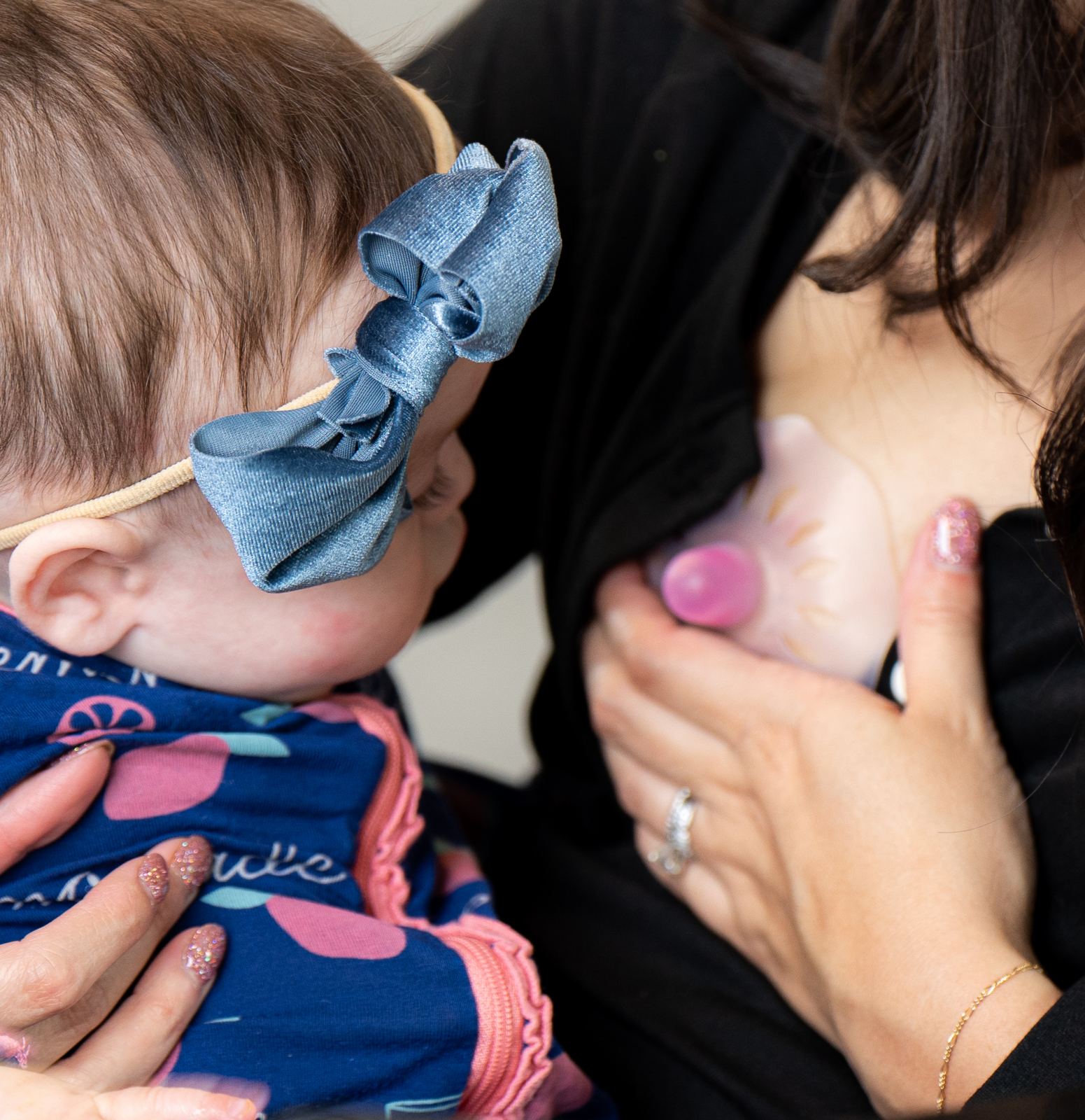 A woman using a Ceres Chill nipple shield while breast feeding. 